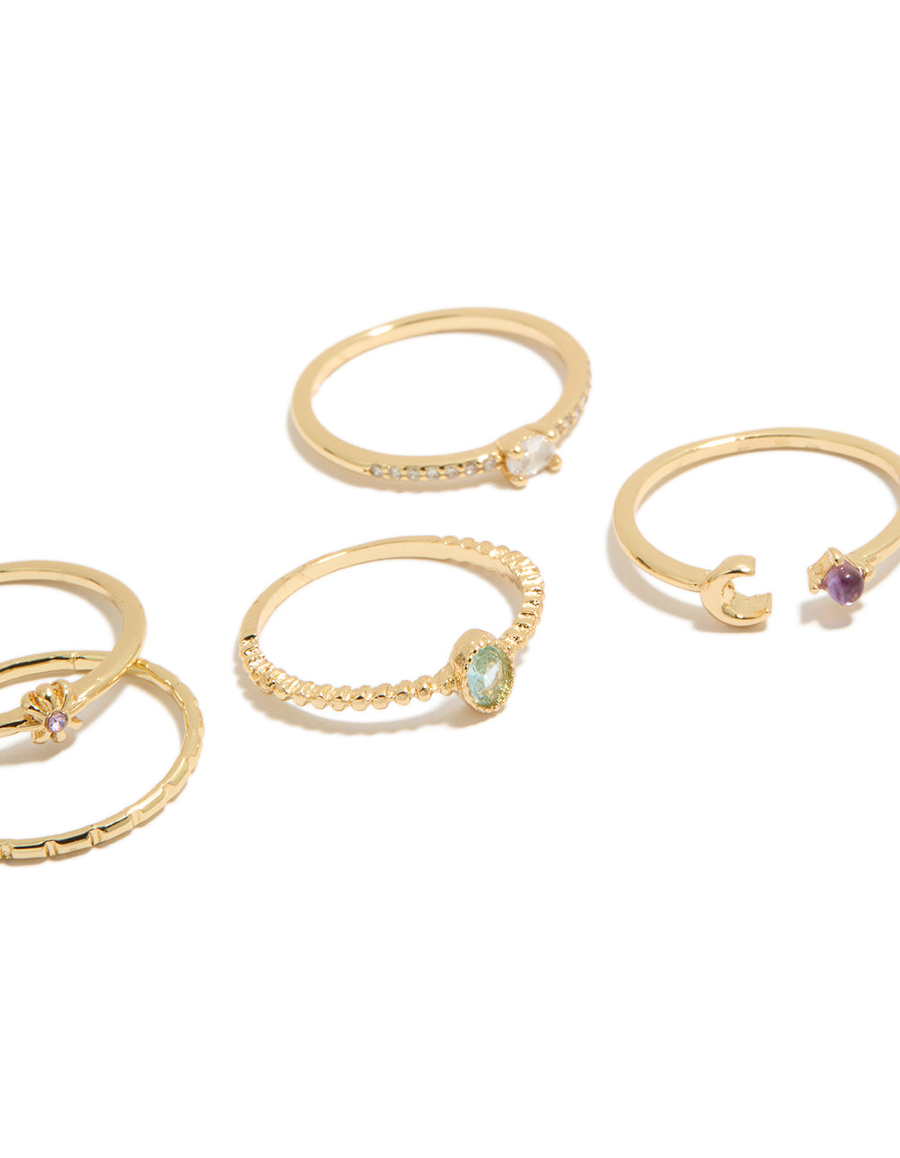 Elegantly arranged five-piece celestial set showcasing moon and sun motifs in gold plated cubic zirconia oval cut dainty rings close up view