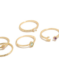 Elegantly arranged five-piece celestial set showcasing moon and sun motifs in gold plated cubic zirconia oval cut dainty rings close up view - link has visual effect only