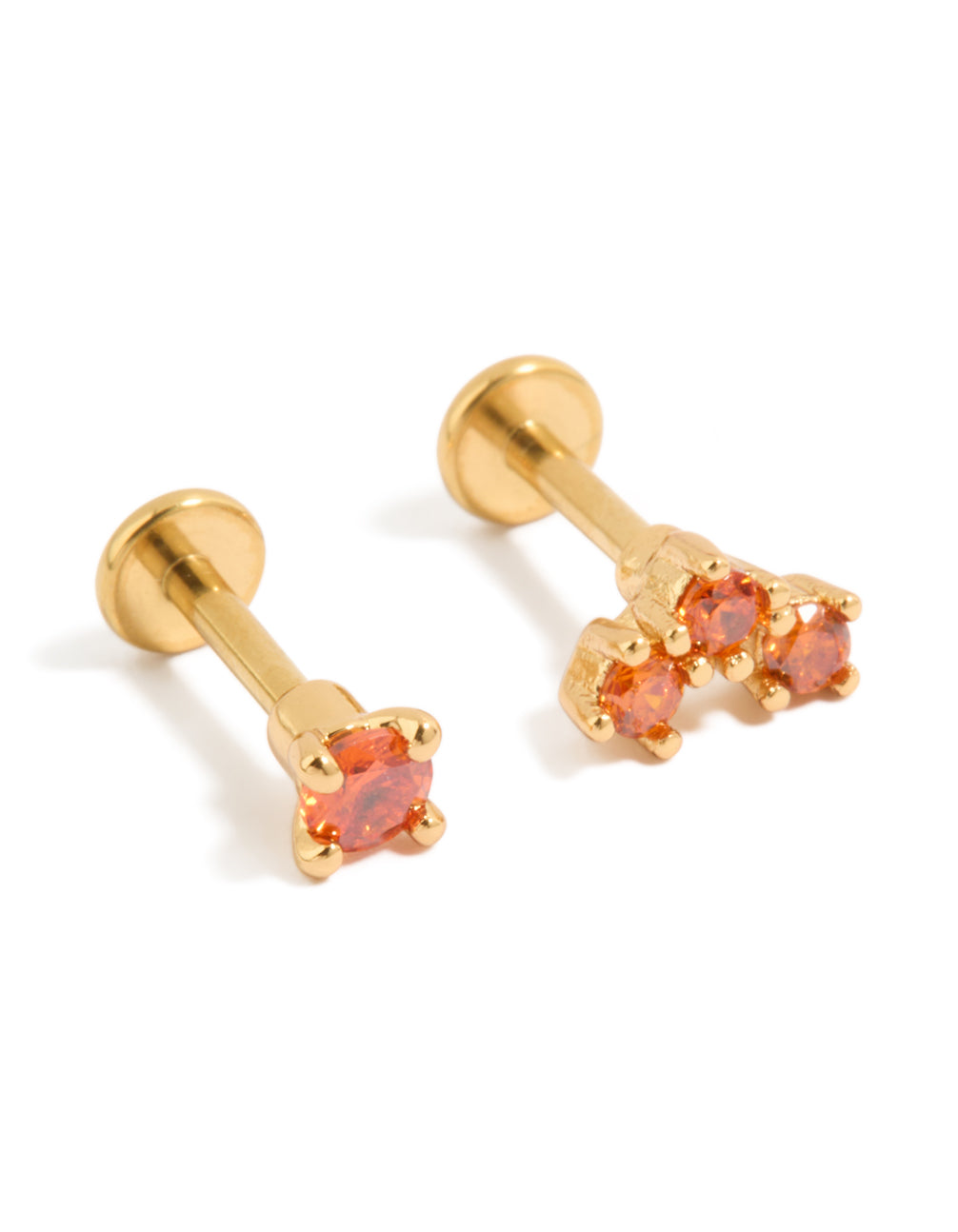 Showcasing gold plated titanium red cubic zirconia flat back studs with red accents front view