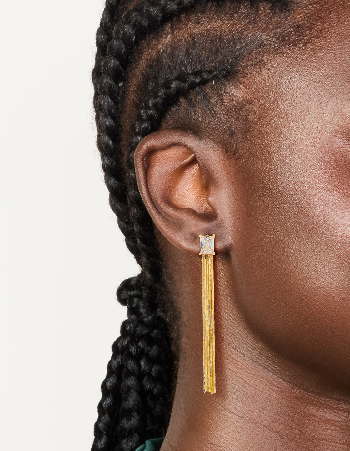 Featuring gold plated cubic zirconia square fringe drop earrings with tassel detailing and statement style on ear view