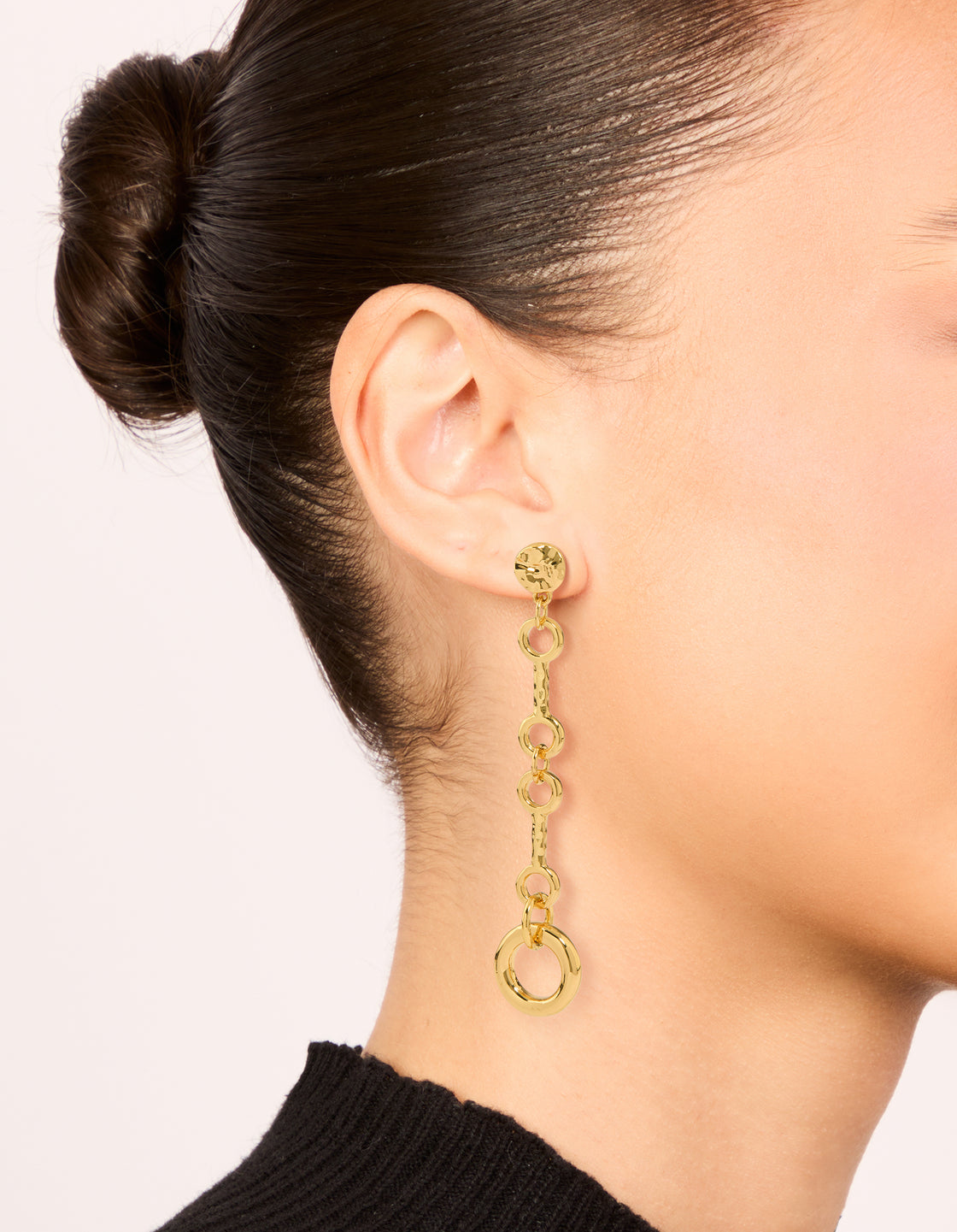 Featuring gold plated molten chain long drop earrings with statement style on ear view