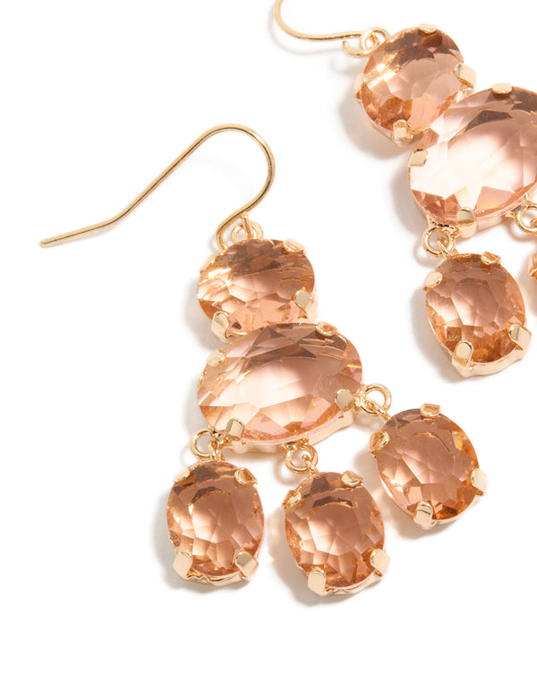 Featuring gold pink stone charm hook drop earrings close up view