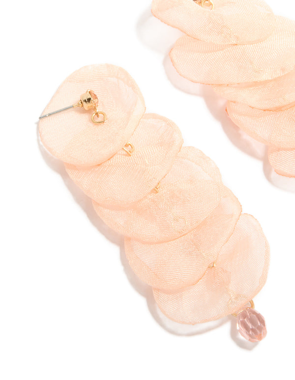 Crafted with pink fabric round layered drop earrings in statement style featuring beads with beige, pink and gold tones close up view