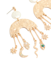 Featuring brushed gold rainbow and celestial charm drop earrings in a statement style, featuring moon, pearl, star, sun, hamsa hand, and snake charms close up view - link has visual effect only