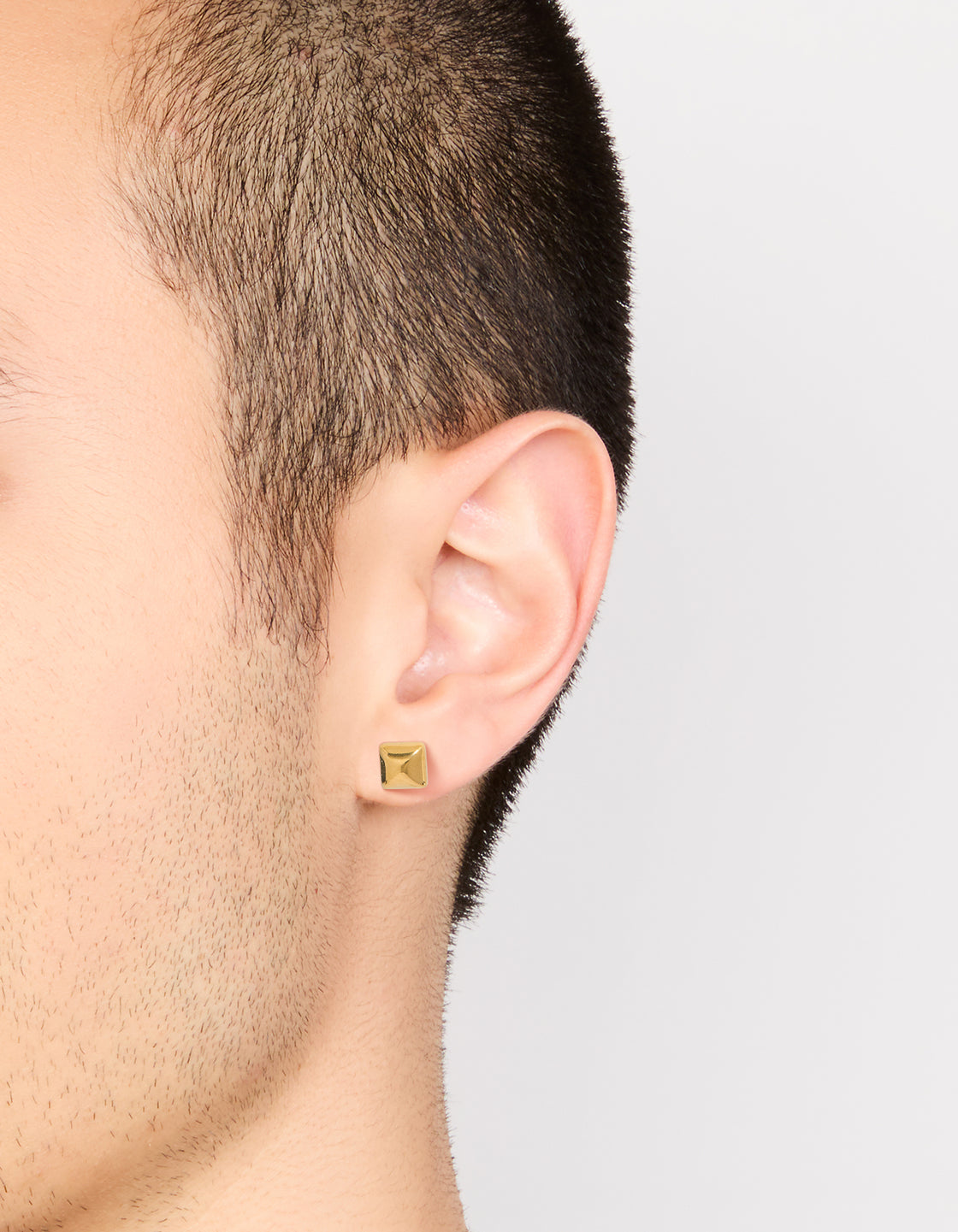 Featuring waterproof gold plated stainless steel square stud earrings on ear view