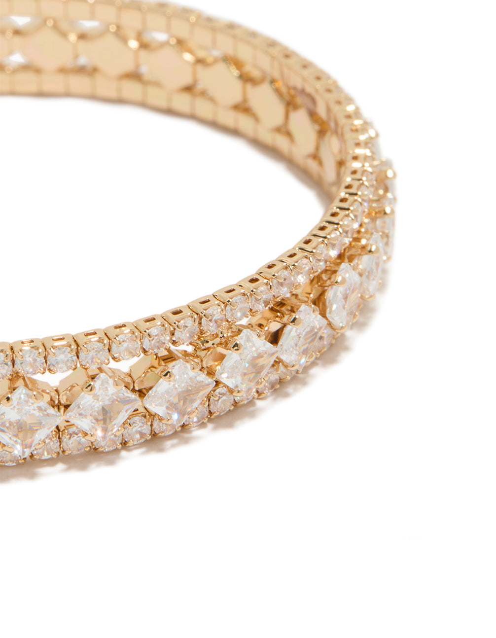 Highlighting a gold cubic zirconia circle statement cuff bracelet close up view