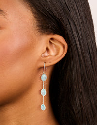 Elegant silver plated blue stone thread through earrings with pale turquoise accents on ear view - link has visual effect only