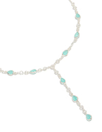 Showcasing a statement necklace crafted from silver plated metal with cubic zirconia oval stones in turquoise close up view - link has visual effect only