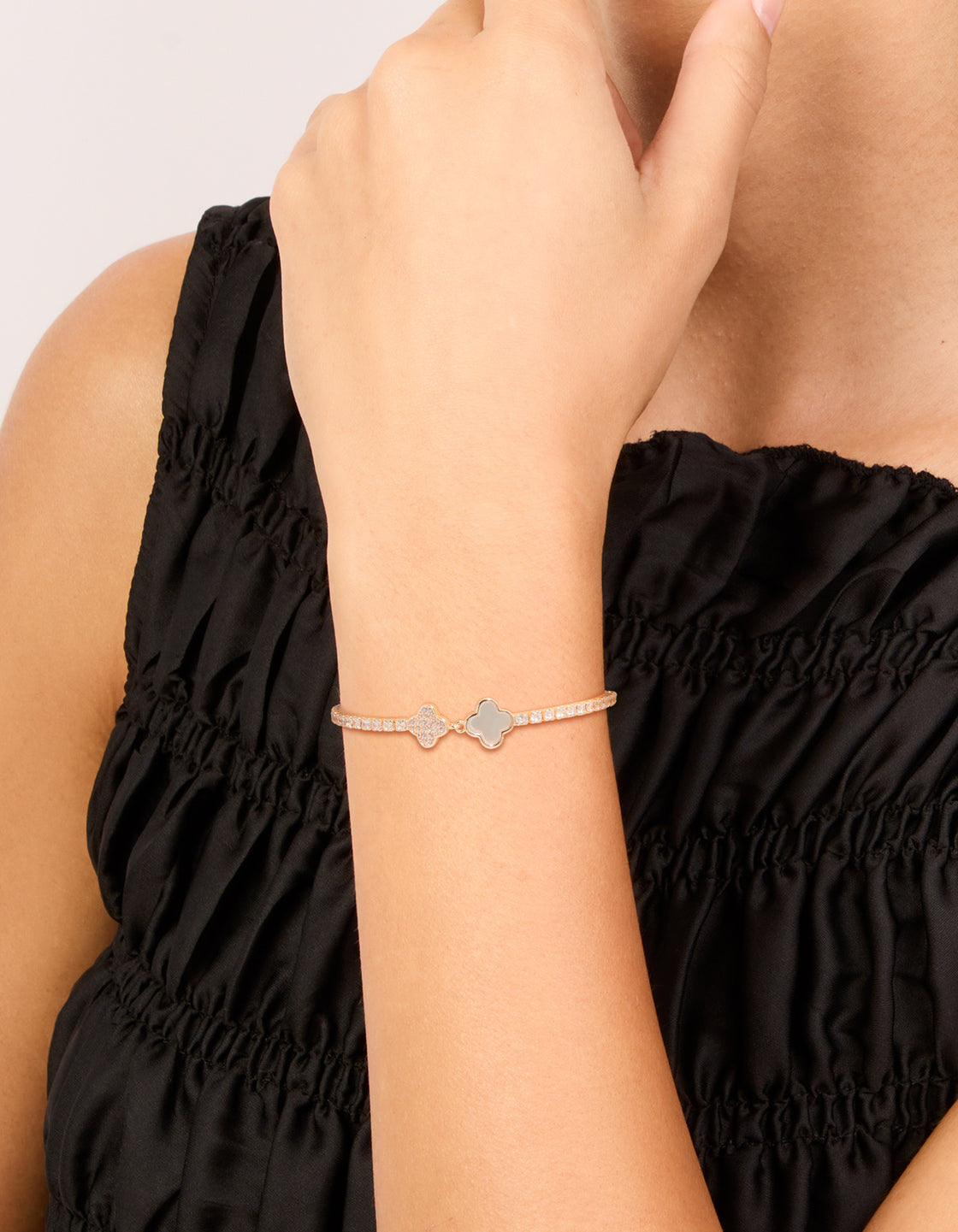 Designed with rose gold plated metal featuring floral with cubic zirconia on wrist view