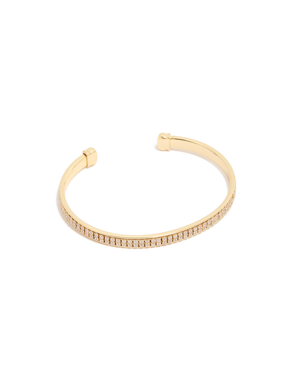 Showcasing a wrist cuff crafted from gold plated material featuring cubic zirconia flat bezel set design front view