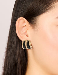 Featuring gold black double lined stud earrings with closure in on ear view - link has visual effect only