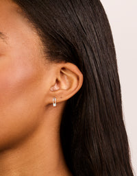 Elegant sterling silver cubic zirconia safety pin stud earrings in a statement style on ear view - link has visual effect only