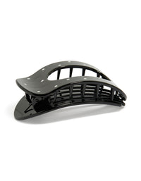 Showcasing a glossy oval claw clip with polkadot print in black and white front view - link has visual effect only