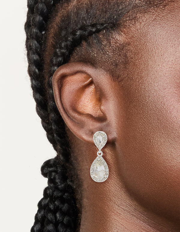 Featuring silver double oval diamante drop earrings with pear cut stones on ear view