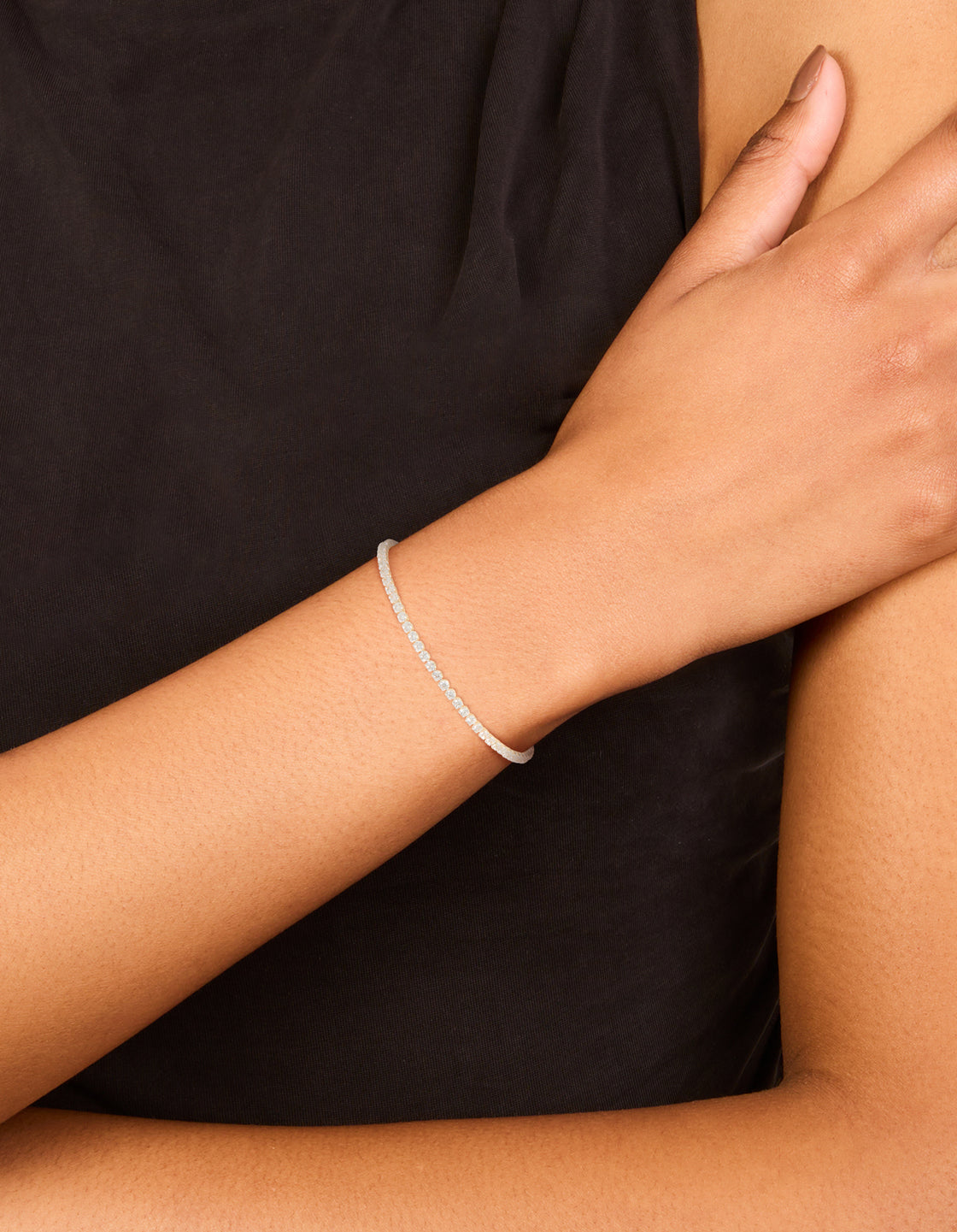 Elegant silver plated cubic zirconia round tennis bracelet in clear on wrist view