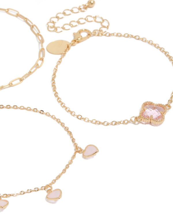 Designed with gold pink diamante flower and heart chain bracelets in a 3-pack featuring charm details and enamel material close up view