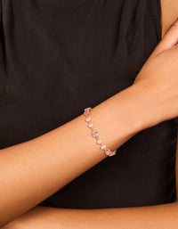 Featuring a bracelet with round stone cut in gold, pink and clear diamantes on wrist view - link has visual effect only