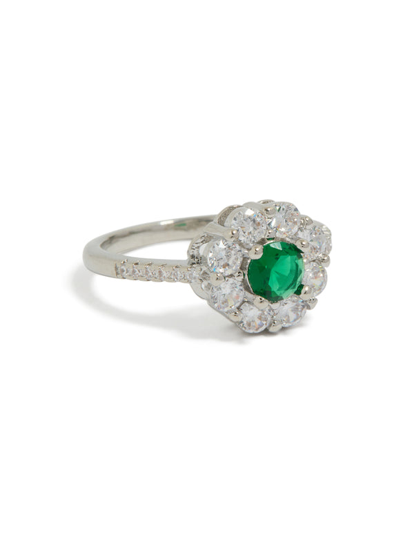 Showcasing a dainty cubic zirconia ring with green center stone and clear halo in silver setting front view