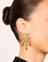 Discover statement drop earrings with floral leaf design featuring orange beads in gold on ear view - link has visual effect only