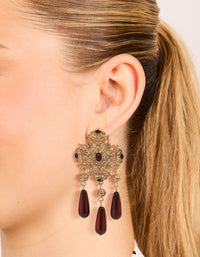 Featuring antique gold art deco drop earrings with charm, and beads accents in maroon on ear view - link has visual effect only