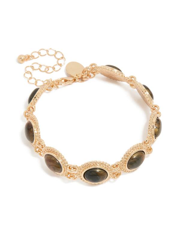 Showcasing a brown oval stone bracelet crafted from gold front view