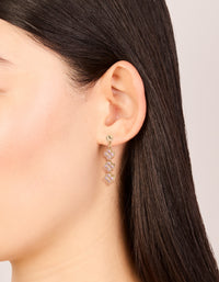 Elegant gold pink cubic zirconia flower trio drop earrings on ear view - link has visual effect only