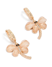 Showcasing pink dragonfly gold huggie hoop earrings with animal charm, wings, and glitter accents front view - link has visual effect only