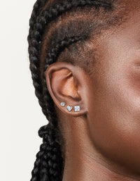 Crafted from waterproof gold plated stainless steel cubic zirconia mixed stud earrings in a 3-pack featuring round stone cut and clear accents on ear view - link has visual effect only