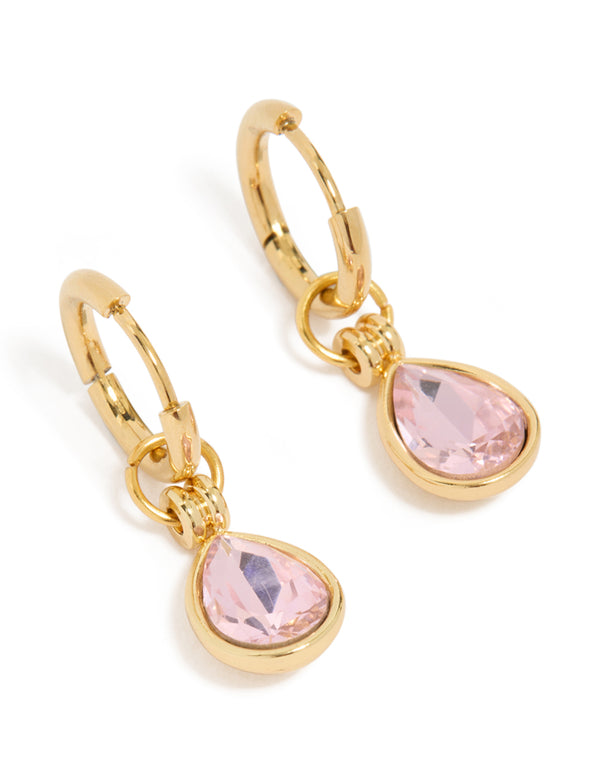 Showcasing waterproof huggie earrings with pink cubic zirconia in pear cut, crafted from gold plated stainless steel and crystal front view