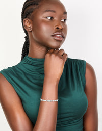 Featuring a waterproof stainless steel cubic zirconia mixed shape bracelet in silver and clear tones on model view - link has visual effect only