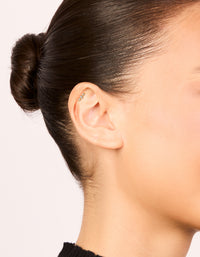 Showcasing a bar crawler earring crafted from surgical steel with cubic zirconia and flat back closure in gold on ear view - link has visual effect only
