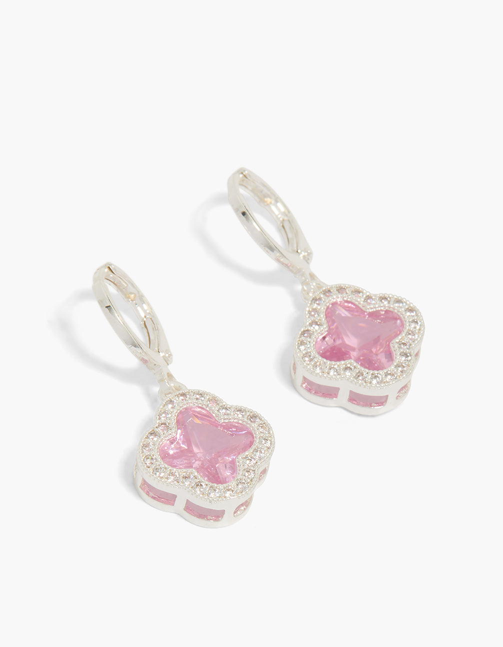 Featuring silver pink cubic zirconia flower huggie earrings front view