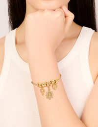 Stunning gold plated cubic zirconia heart and cross toggle bracelet featuring charms, and crystal details on wrist view - link has visual effect only