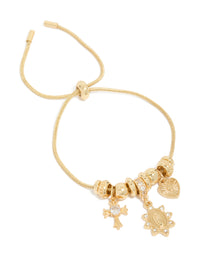Beautifully crafted gold plated cubic zirconia heart and cross toggle bracelet with charms, and crystal accents in gold front view - link has visual effect only
