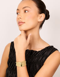 Featuring a statement wavy wrist cuff crafted from plated metal in gold bangle on model view - link has visual effect only