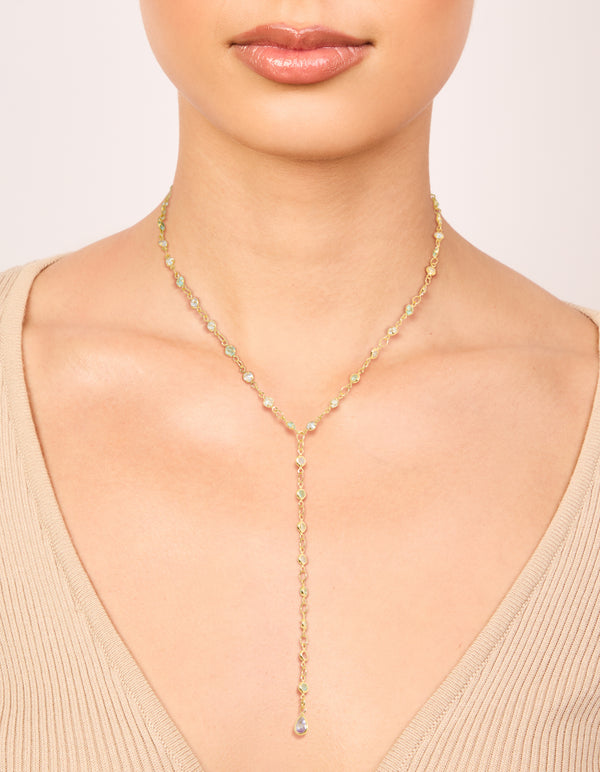 Crafted from gold plated materials, this cubic zirconia blue circle detail Y-necklace in dainty design on neck view