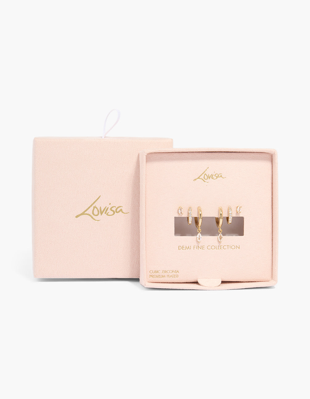Featuring gold plated cubic zirconia marquise drop and stud earrings 3-pack with crystal features, huggie and stud closures in packaging close up view