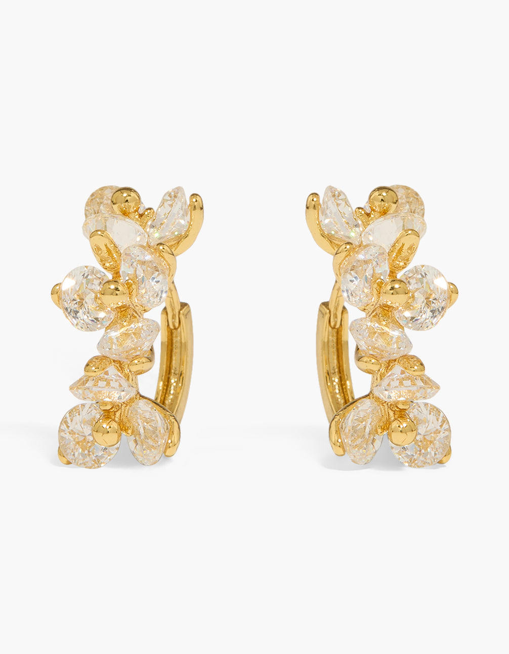 Showcasing dainty floral huggie earrings crafted from gold plated material featuring cubic zirconia in a clear and gold color front view