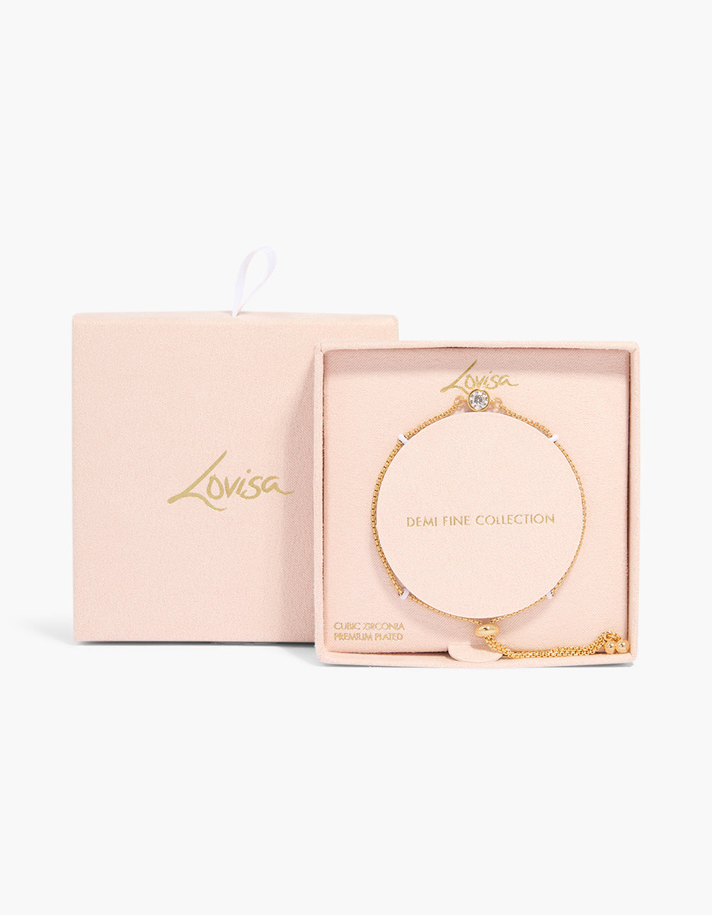 Presenting a gold bezel round cubic zirconia toggle bracelet with crystal accents in plated metal in a packaging close up view